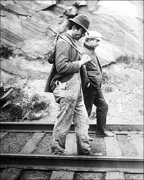 Traveling Hikers Tramp on a Railroad Track Photo Print for Sale